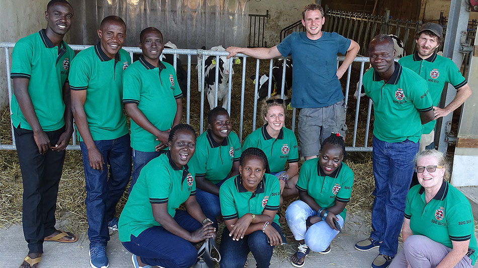 Photo of a group of participants in front of a cowshed.