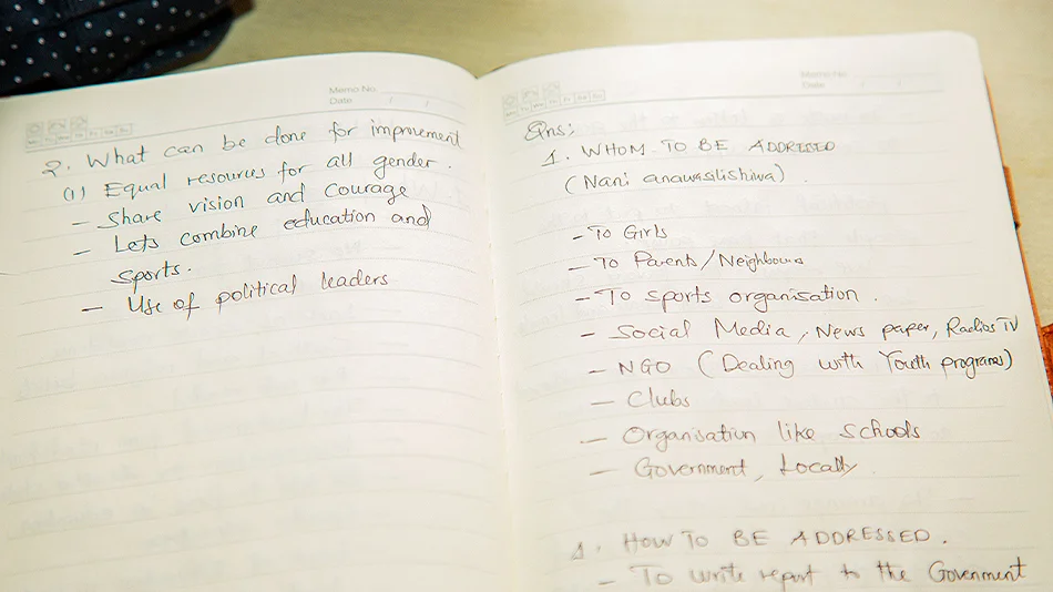This photo shows two pages of a notebook. On the left there is a list of points under the heading “What can be done for improvement”. The lists on the right are headed “Whom to be addressed” and “How to be addressed”.